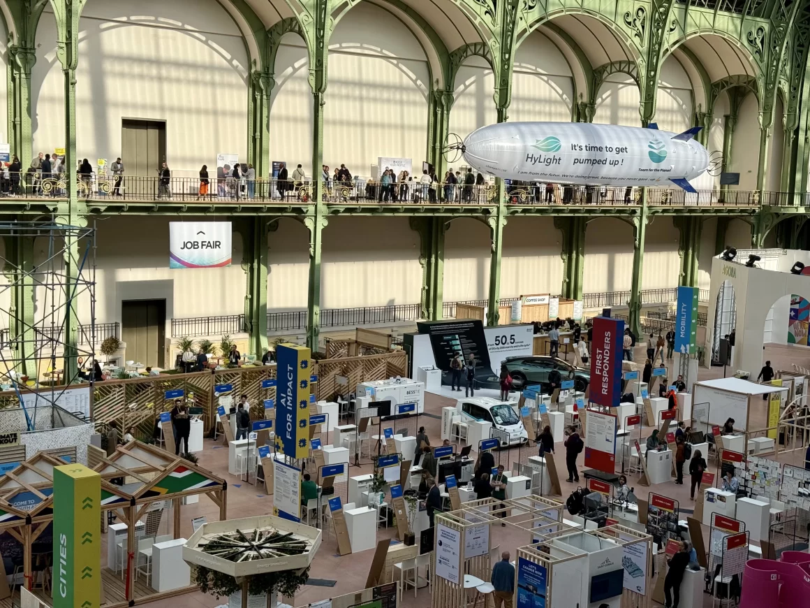 Exhibition floor at ChangeNOW 2025 inside the Grand Palais, photographed by Juan Daniel Correa, showing innovation booths, mobility solutions, climate-tech projects and participants exploring the summit’s solution-driven spaces.