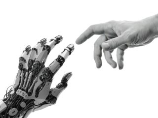 Human and robotic hands reaching toward each other, symbolizing the relationship between human creativity and artificial intelligence.