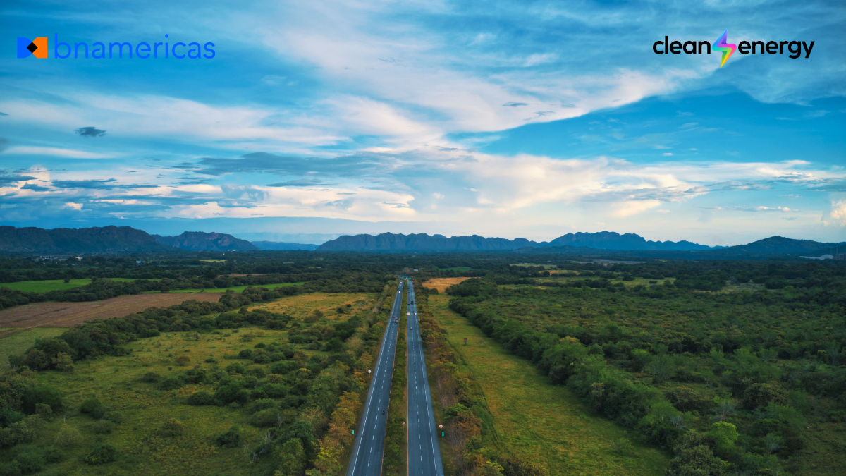 Aerial view of a highway crossing Colombia’s green landscape toward the mountains, with the BNamericas and Clean Energy logos.